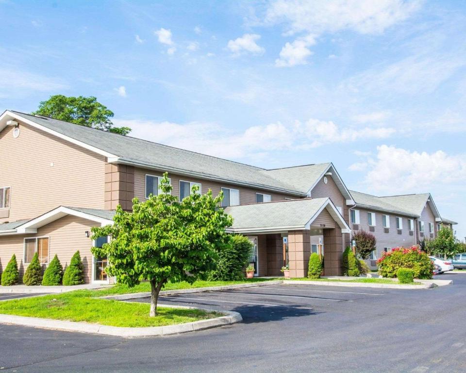 a large building with a tree in front of it at Quality Inn in Lewiston