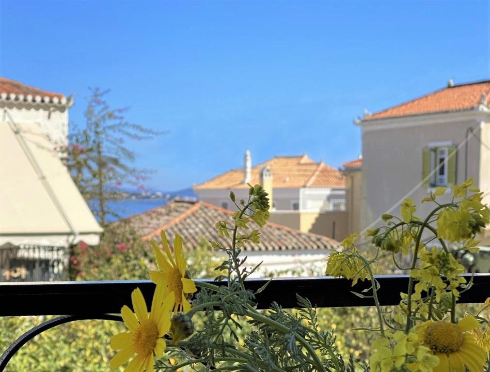a view of some yellow flowers on a balcony at Summer house in Spetses in Spetses