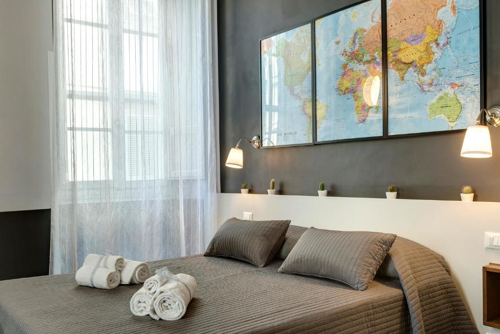- une chambre avec un grand lit et des serviettes dans l'établissement Al Consolato, à Florence