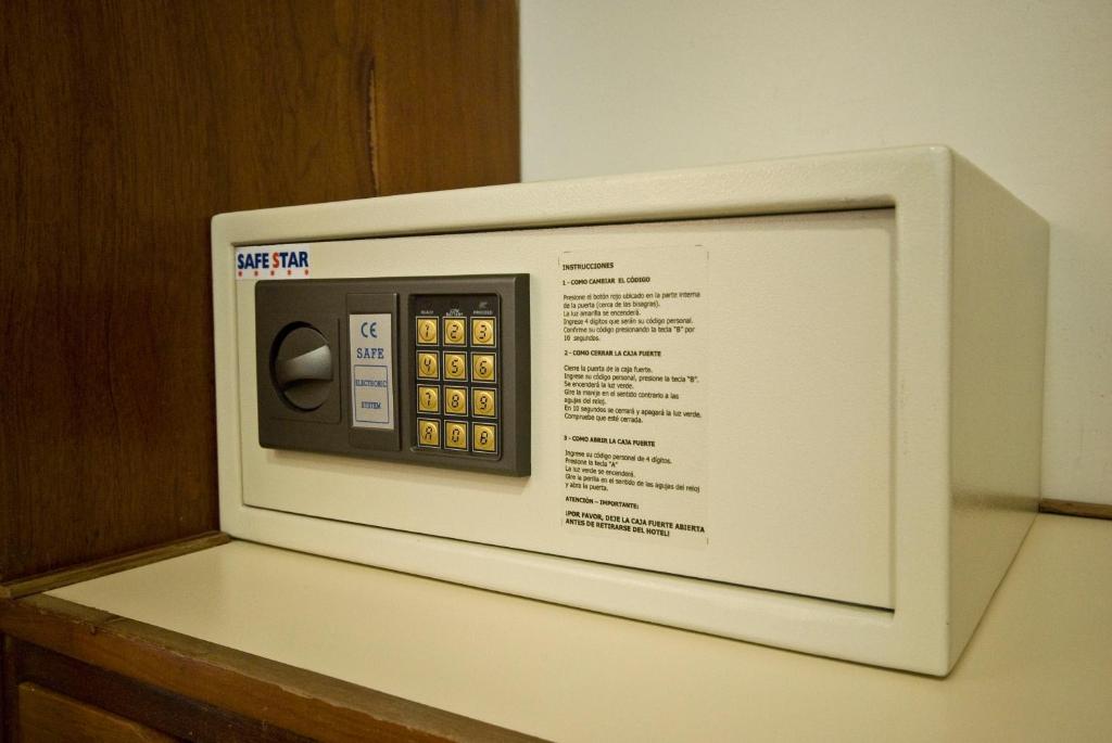 a white microwave oven sitting on top of a counter at Comodoro Hotel in Comodoro Rivadavia