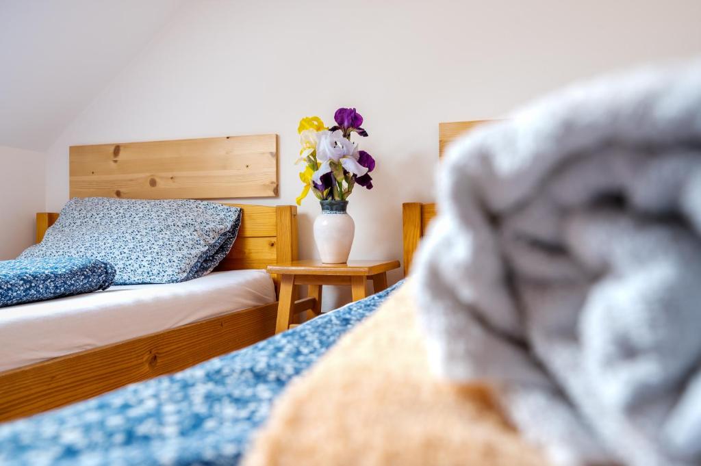 a bedroom with a bed and a vase of flowers at Penzion U Kostela in Mikulčice