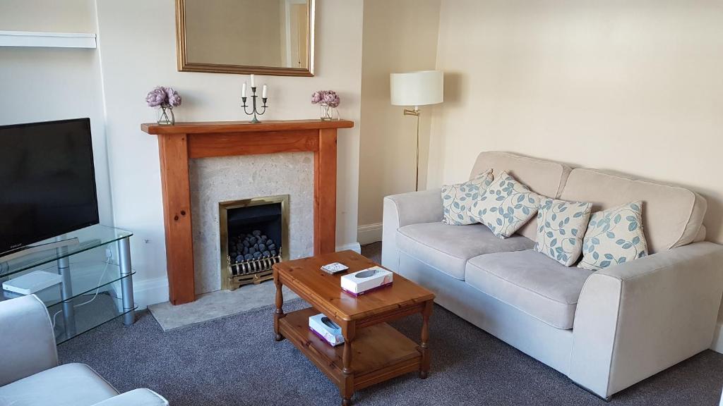 a living room with a couch and a fireplace at Beverley East Townhouse Free Parking in Beverley