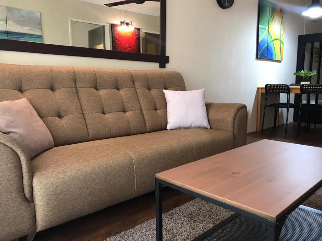 a living room with a couch and a table at Homestay Fekrifarisha SA in Shah Alam