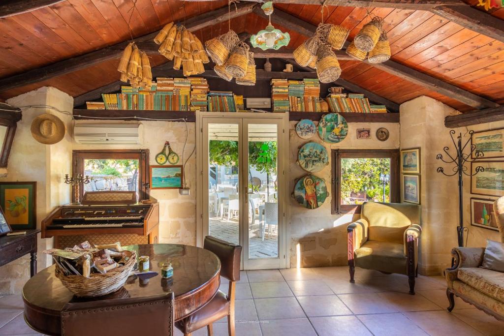 a living room with a wooden ceiling and a table at Agriturismo Val Di Noto in Noto