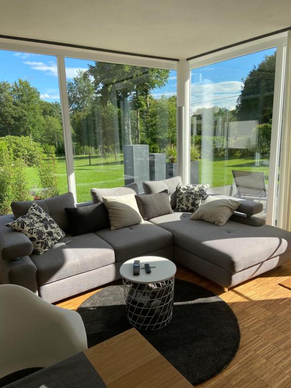 a living room with a couch and a large window at MONzeit in Monschau