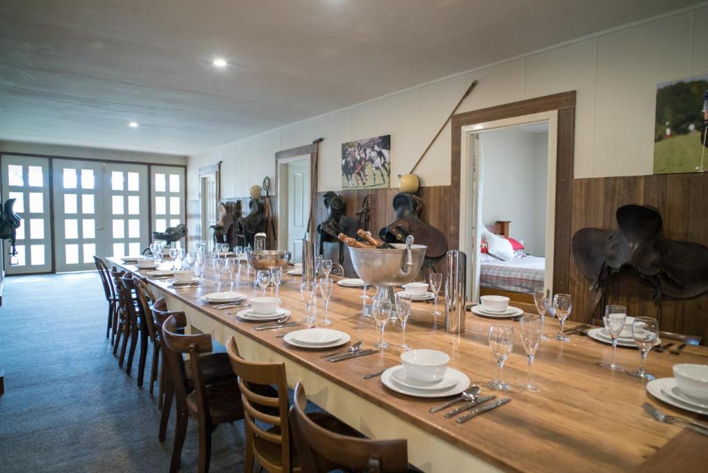 a long table with chairs and wine glasses on it at Fentons Run Southern Highlands in Joadja Creek