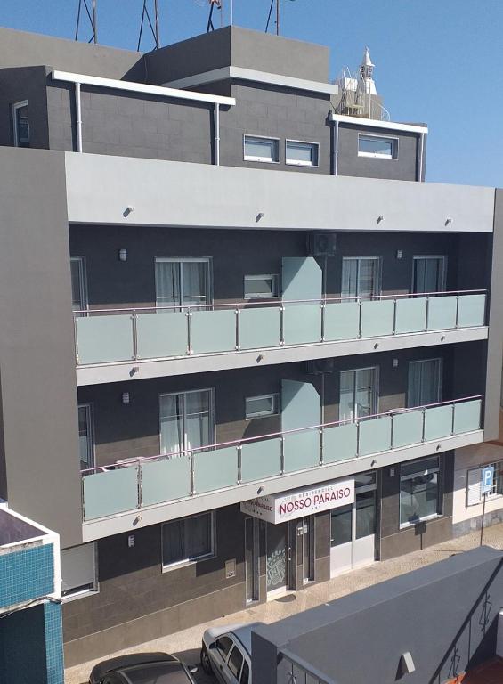 a building with a sign on the side of it at Residencial Nosso Paraiso in Quarteira