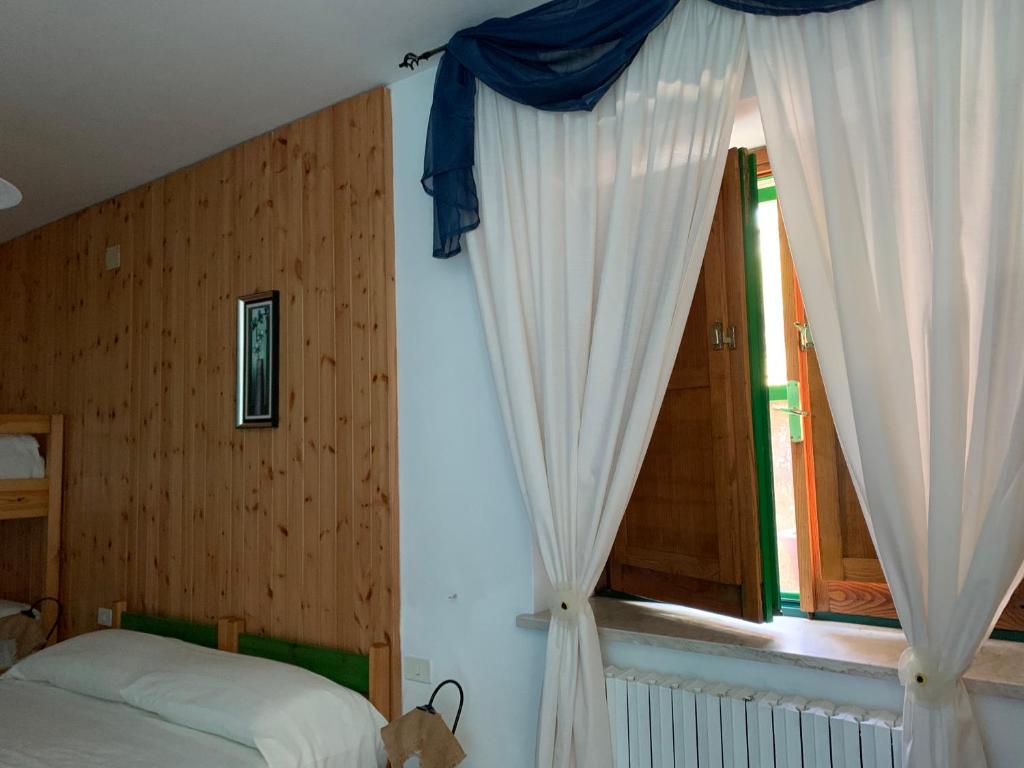 Postel nebo postele na pokoji v ubytování Residence il Varco del Pollino