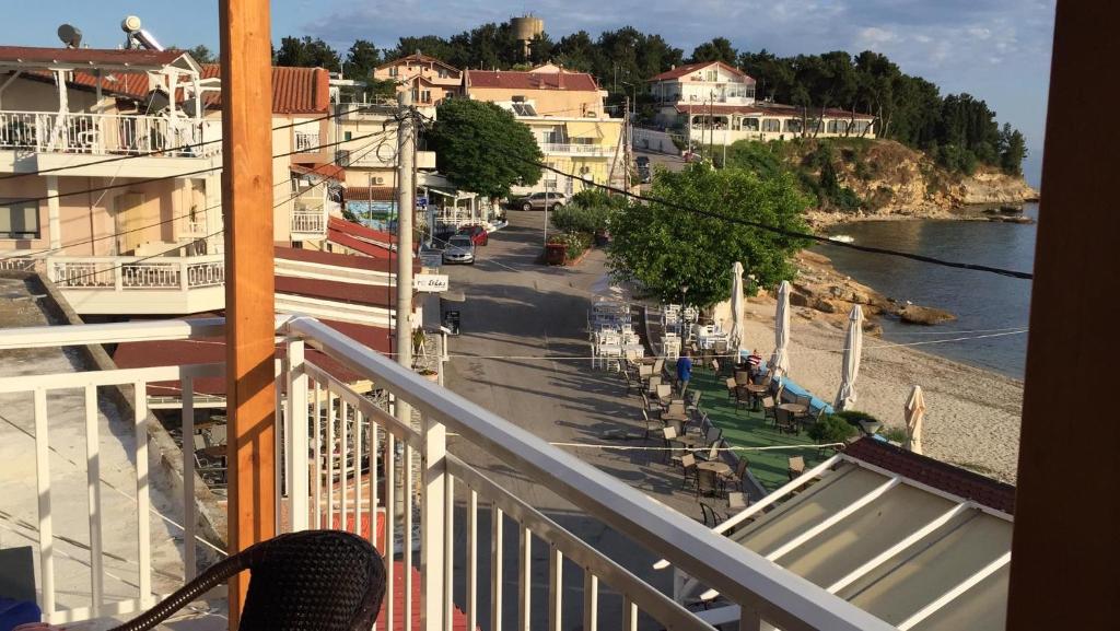a balcony with a view of a street and the water at Emy Studios in Fanari