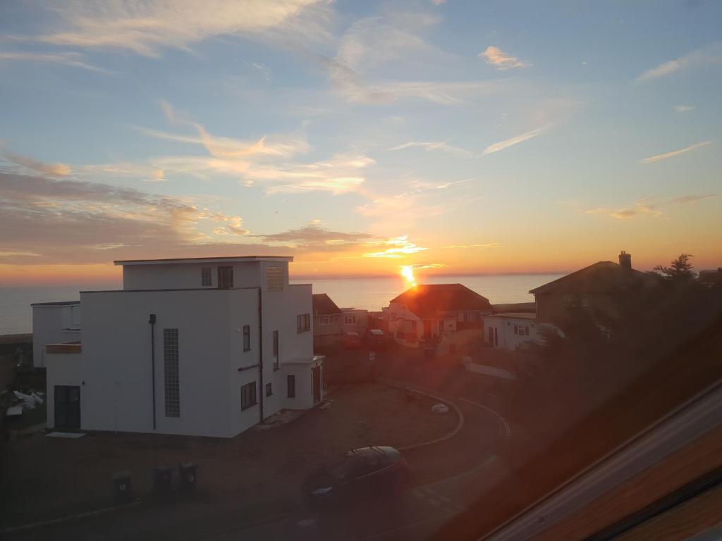 a view of the sunset from a building at Sandy Feet Retreat in South Hayling