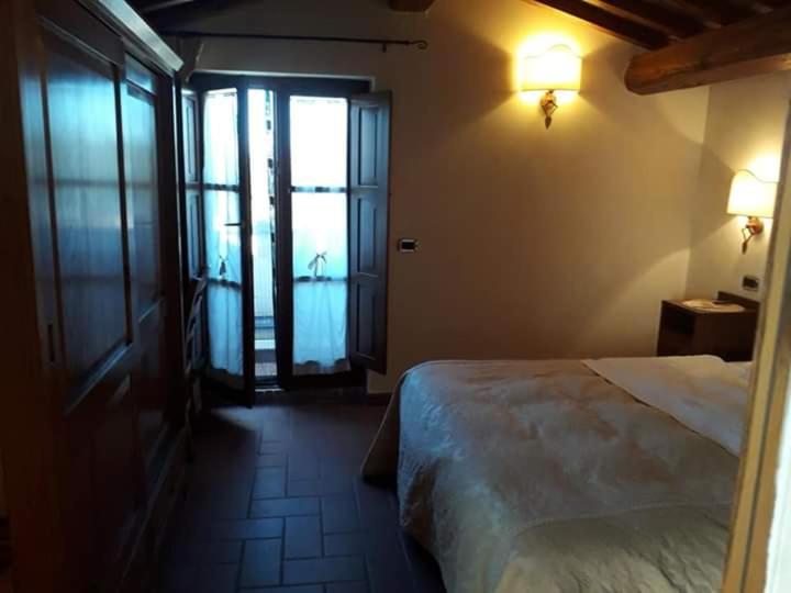 Postel nebo postele na pokoji v ubytování Agriturismo Lupo Cerrino