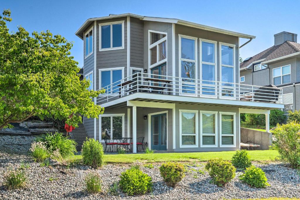 a large house with a balcony on top of it at Modern Retreat with Hot Tub - Steps to Lake Chelan! in Manson