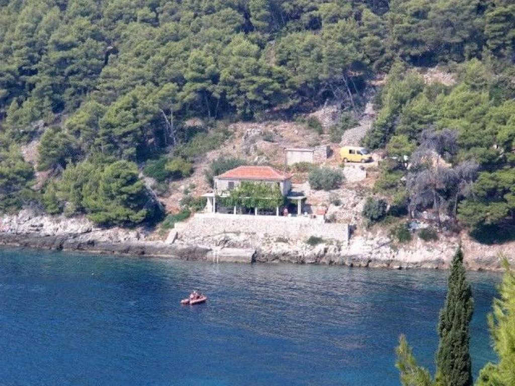 a house sitting on the side of a river at House Slavka in Gdinj