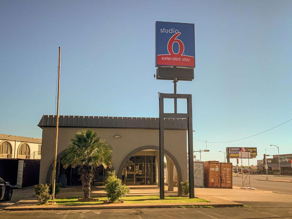 a store with a sign in front of a building at Studio 6 San Angelo, Tx in San Angelo