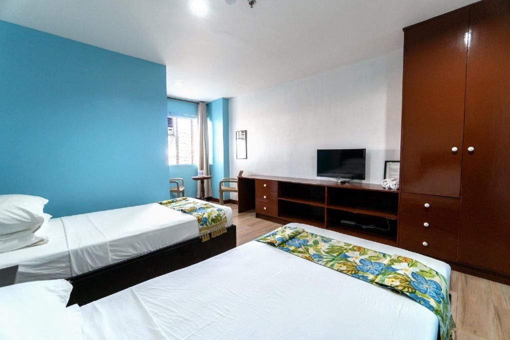 Postel nebo postele na pokoji v ubytování One Averee Bay Hotel