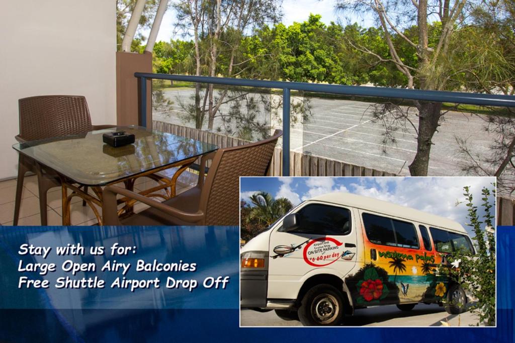 a small van parked on a balcony with a table at Novena Palms Motel in Brisbane