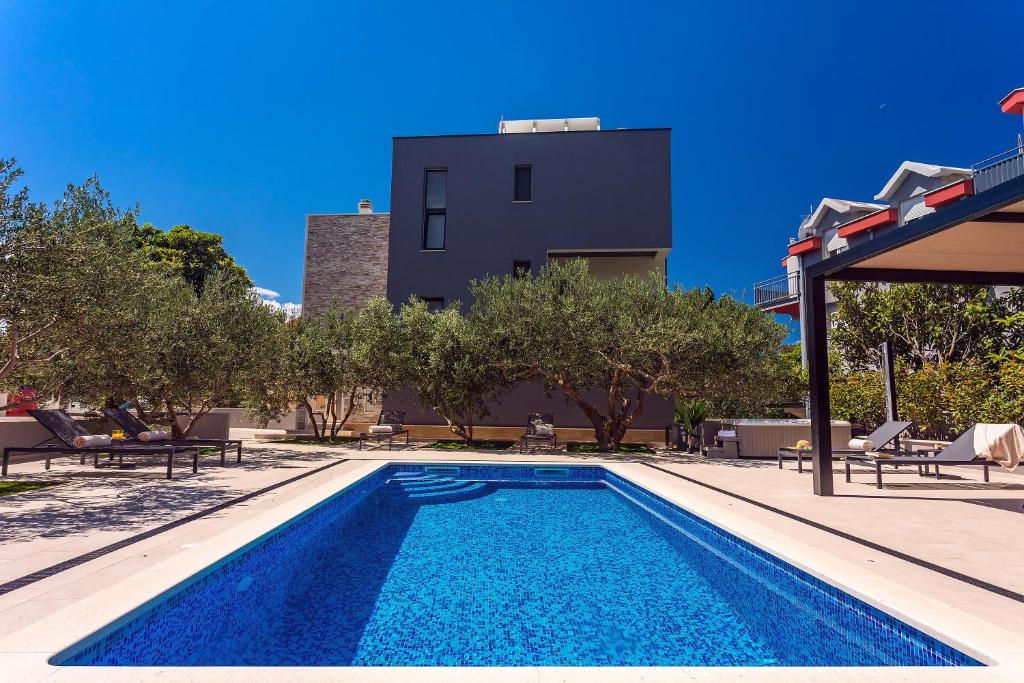 a swimming pool in front of a villa at Villa Topaz in Dugi Rat