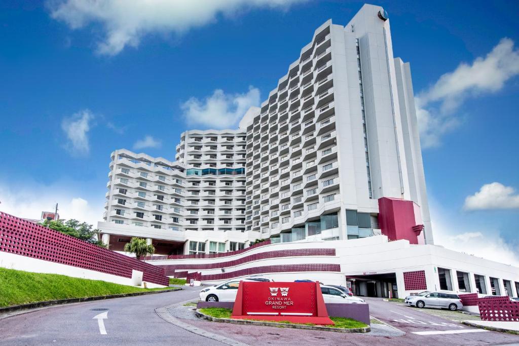 a large building with a large clock on the side of it at Okinawa Grand Mer Resort in Okinawa City