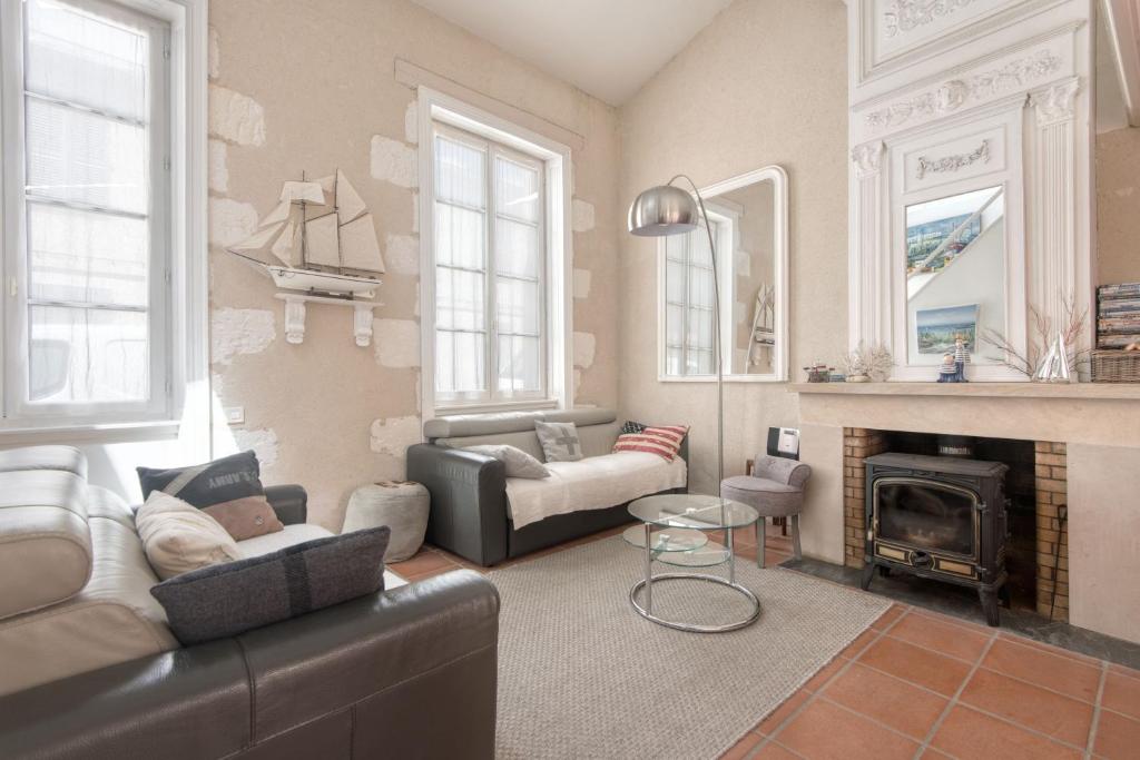 a living room with a couch and a fireplace at Appartement Fauvette in Saint-Martin-de-Ré