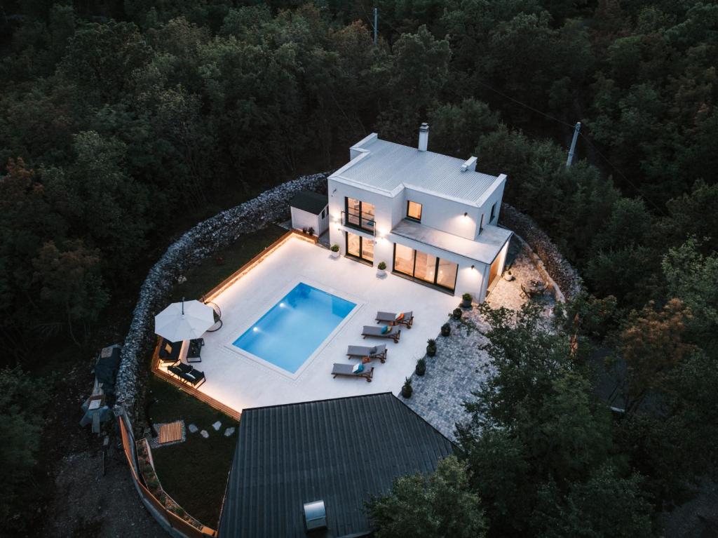 an aerial view of a house with a swimming pool at Villa Moretto with outdoor swimming pool and jacuzzi in Viskovo