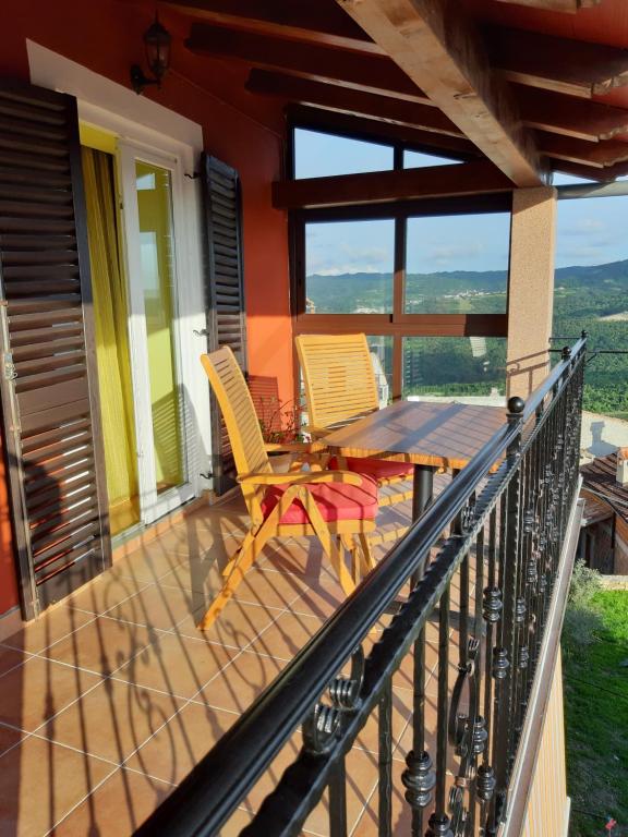 a balcony overlooking a beach with a view of the ocean at Guesthouse Villa Marija in Motovun