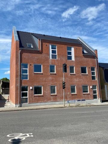 a red brick building on the corner of a street at Just-Sleep in Brande