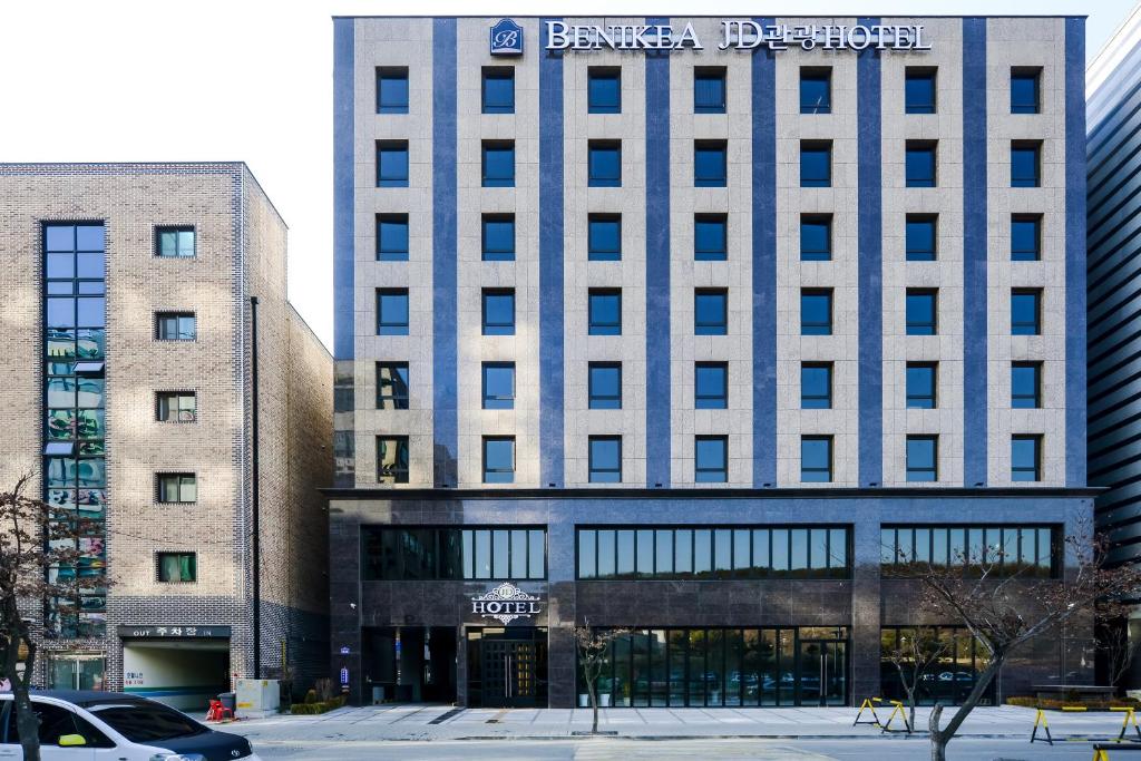 a building with a sign on the front of it at Namyangju Benikea JD Hotel in Namyangju