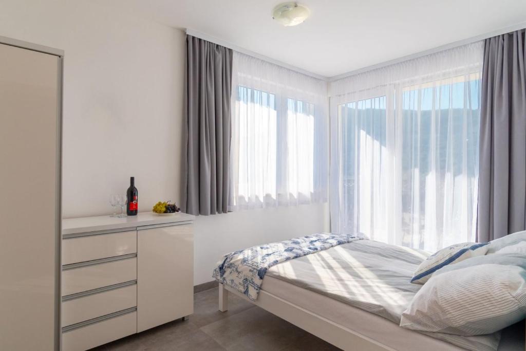 Postel nebo postele na pokoji v ubytování Apartmani Dalmacjia