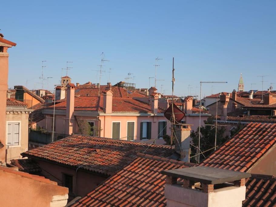 a view of roofs of buildings in a city at Cà Dolce Attico in Venice