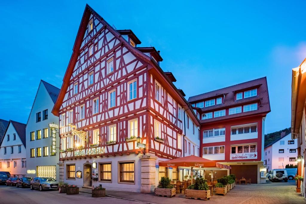
a large building with a clock on the front of it at Hotel-Restaurant Ochsen in Blaubeuren
