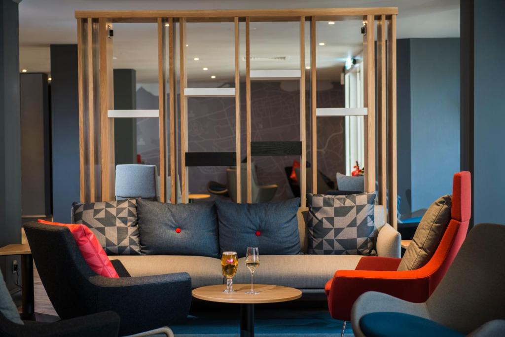 a living room with a couch and chairs and a table at Holiday Inn Express Edinburgh - Leith Waterfront by IHG in Edinburgh