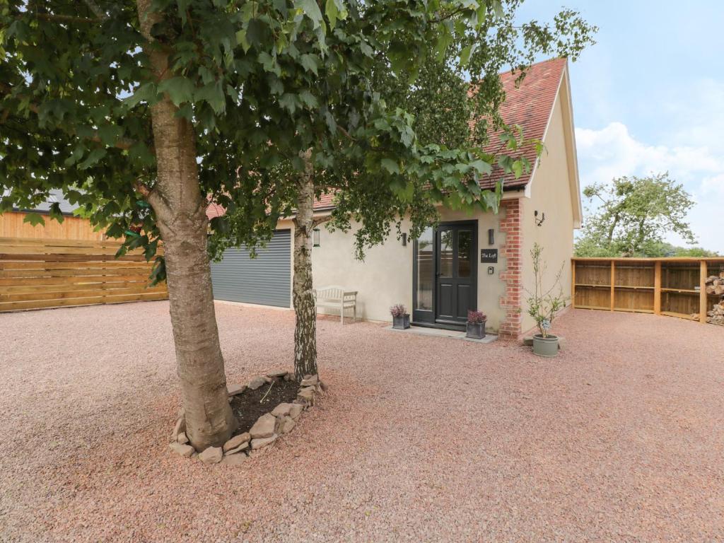 a house with two trees in front of it at The Loft in Hereford