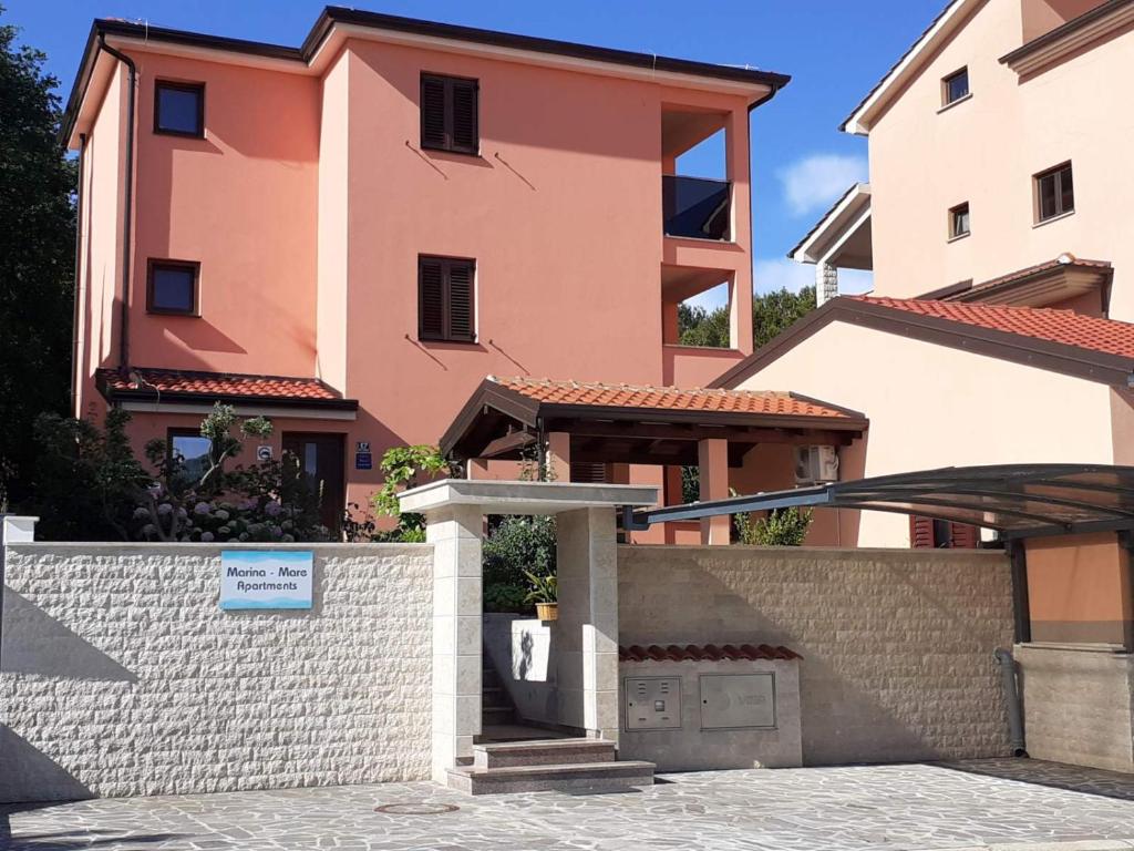 a building with a gate in front of it at Apartments Marina-Mare in Poreč