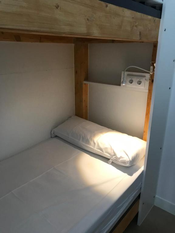 A bed or beds in a room at Albergue O Pedrón Hostel & Rooms