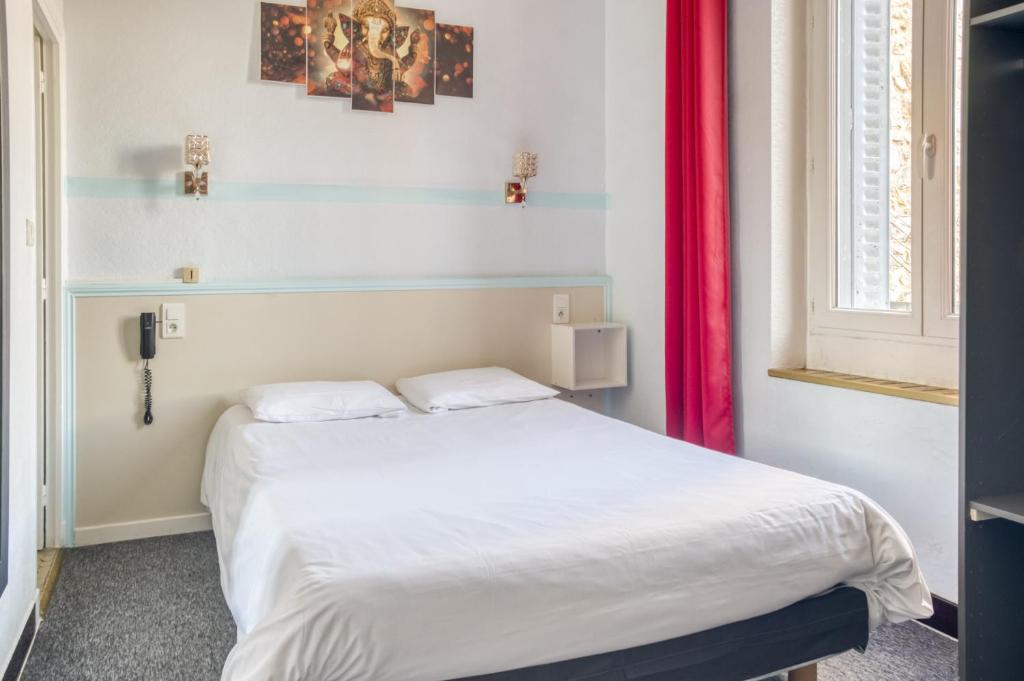Postel nebo postele na pokoji v ubytování Citotel Hôtel Cesar