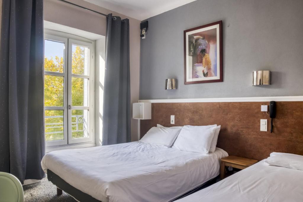 Postel nebo postele na pokoji v ubytování Citotel Hôtel Cesar