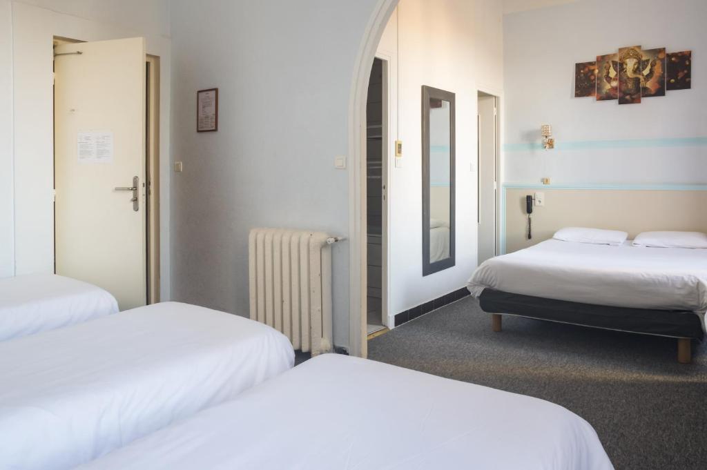Postel nebo postele na pokoji v ubytování Citotel Hôtel Cesar