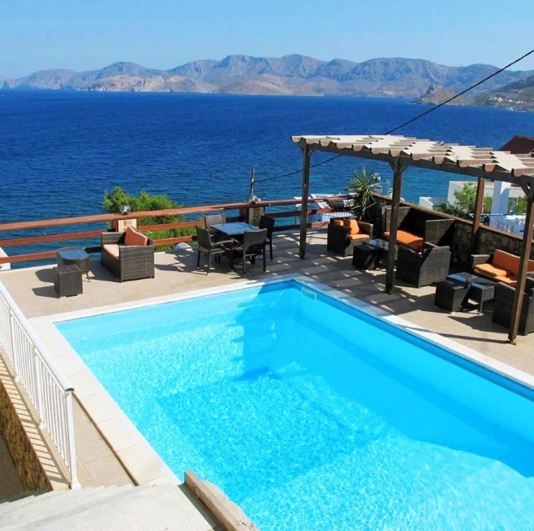 a swimming pool with a view of the ocean at Kalymnos Village in Masouri