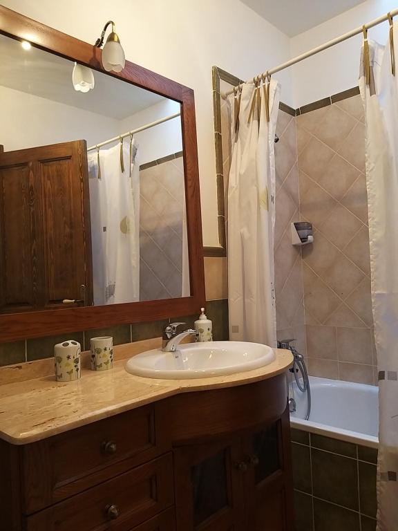 a bathroom with a sink and a mirror and a tub at Casa Rural EL VALLECILLO in Valle de Tabladillo