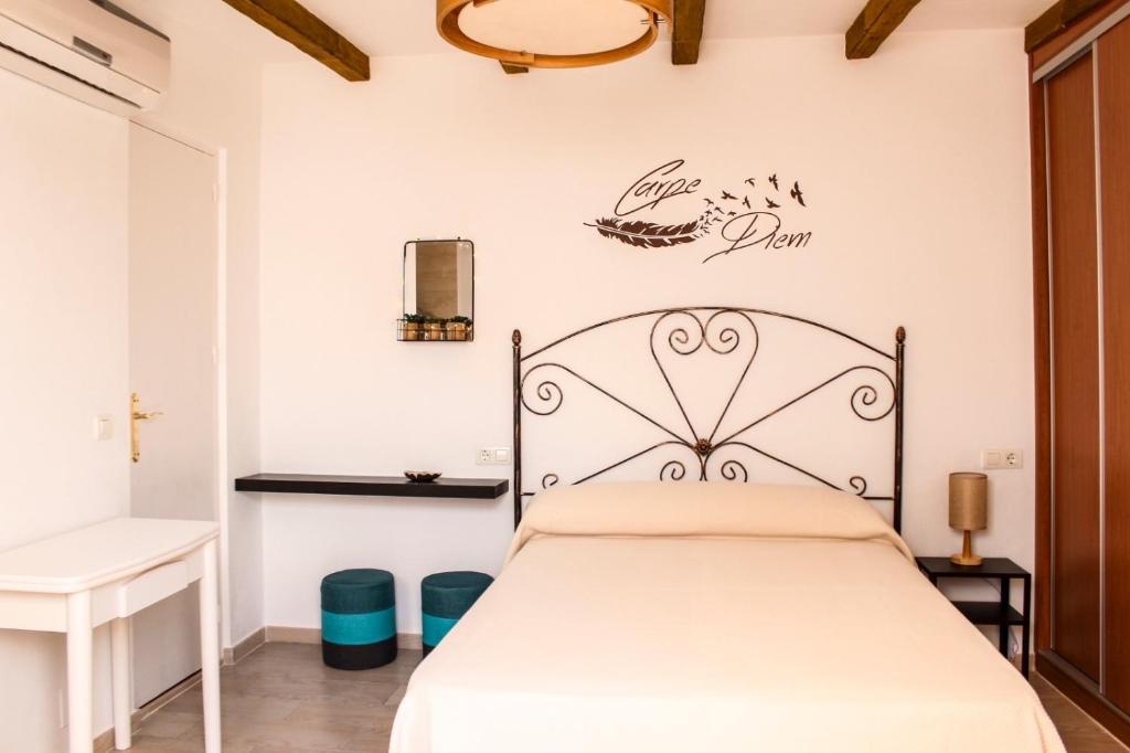 1 dormitorio con 1 cama y un cartel en la pared en Apartamentos La Mar Chica en Benalmádena