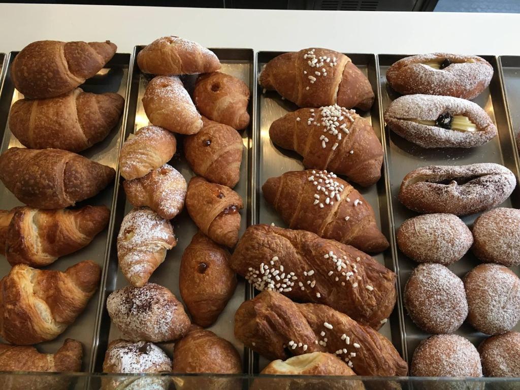 a display case filled with lots of donuts and pastries at RosAmar in Bari