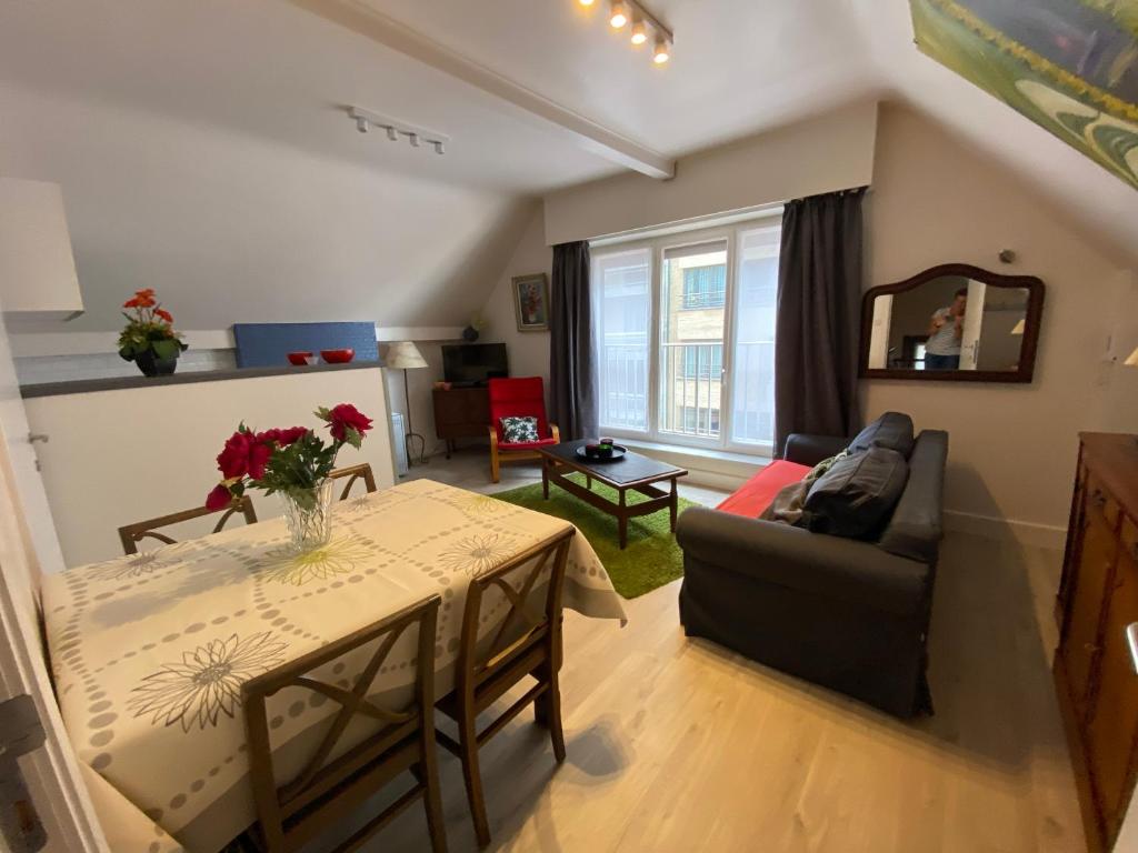 a living room with a table and a couch at Apartment Van Hecke in Blankenberge