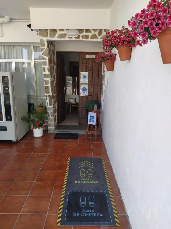 a entrance to a building with a sign on the floor at Mar de Rosas in O Grove