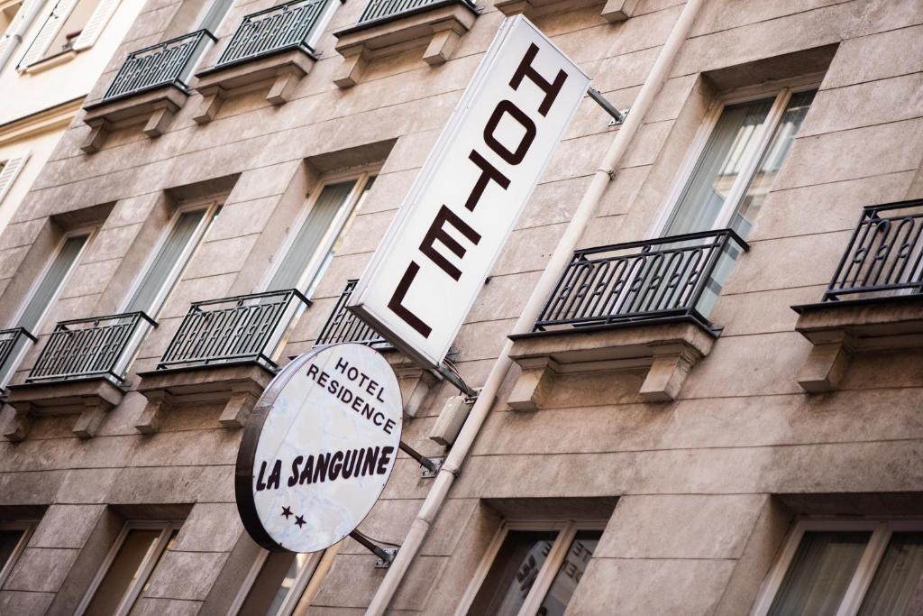 a hotel sign on the side of a building at Hôtel La Sanguine in Paris