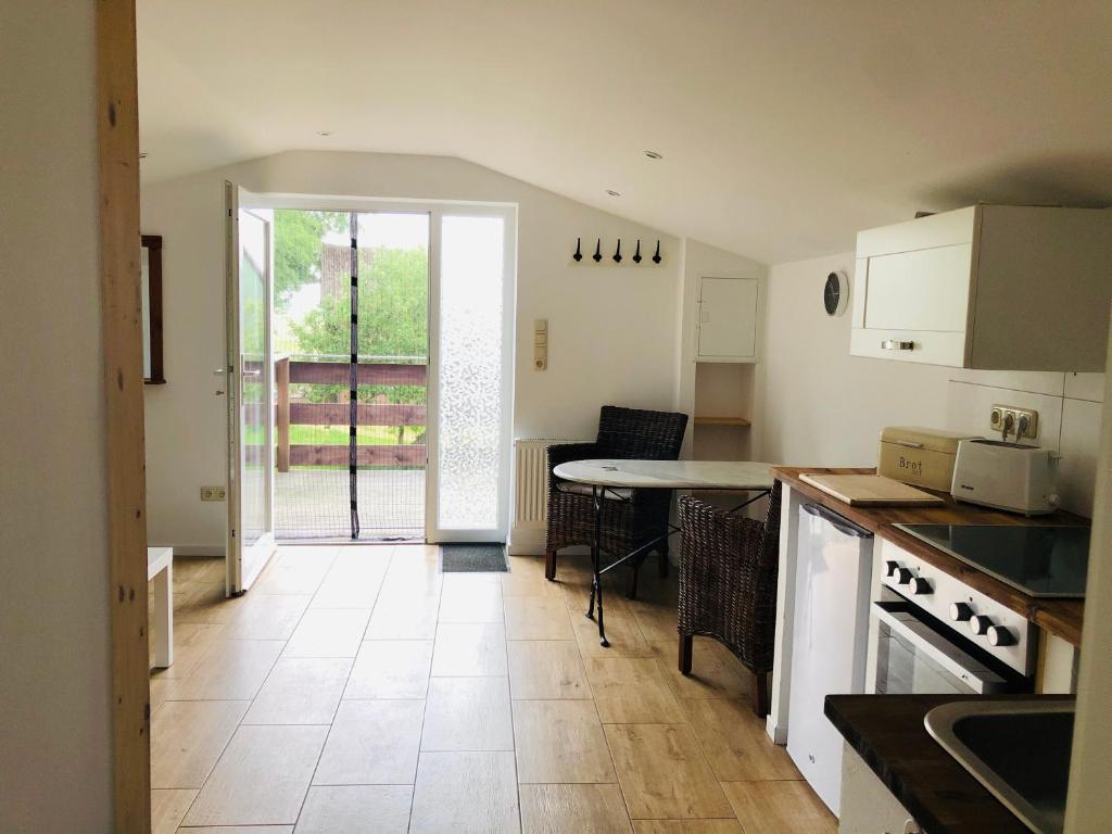 a kitchen with a table and a counter top at Ferienwohnung Eiderblick in Hennstedt