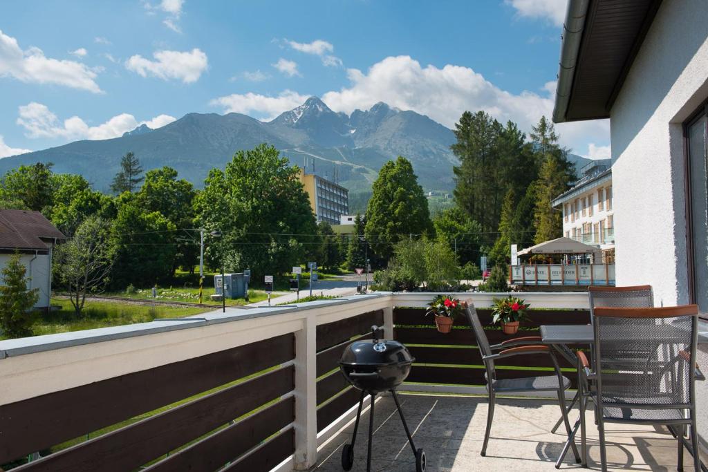 a balcony with chairs and a view of mountains at Vila Mala Marta in Tatranská Lomnica
