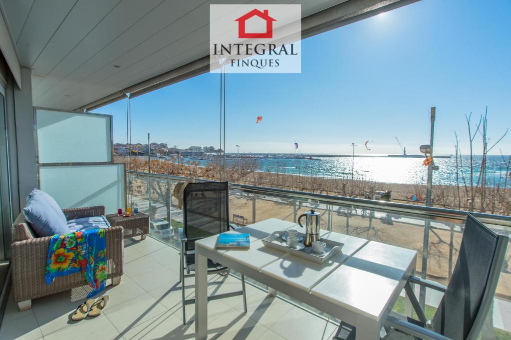 a view of the beach from the balcony of a beach house at Palamós BeachFront Apartment in Palamós