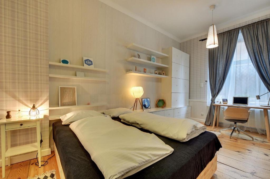Posteľ alebo postele v izbe v ubytovaní Grand Apartments