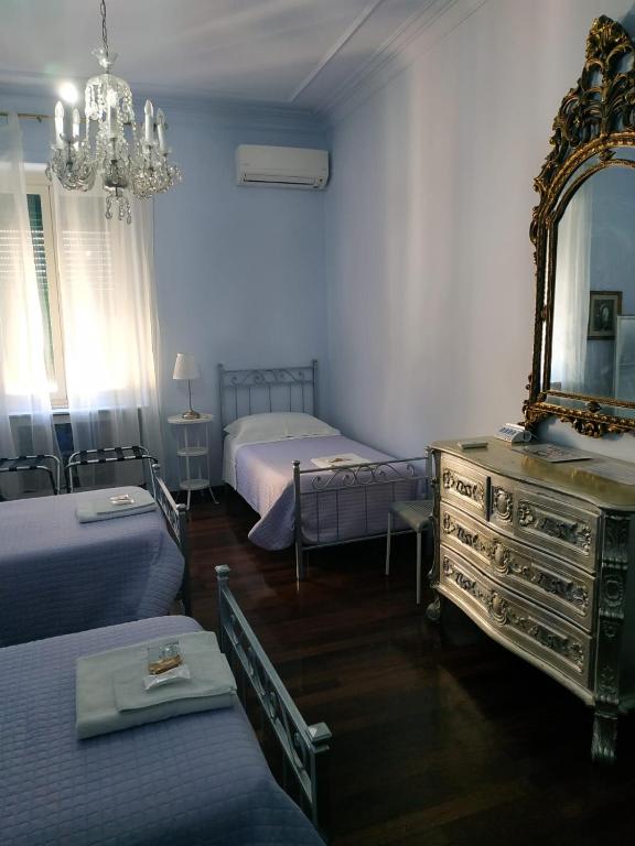 A bed or beds in a room at Around The Corner Colosseo B&B
