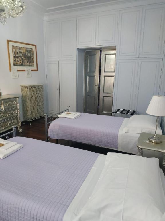 A bed or beds in a room at Around The Corner Colosseo B&B